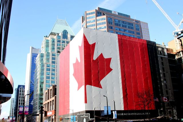 1280px-Canadian_flag_on_building